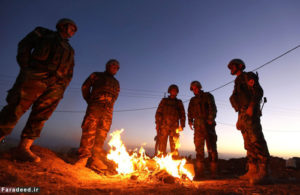 Iraqi Kurdish Peshmerga fighters stand next to a fire as they gather on the top of Mount Zardak, about 25 kilometres east of Mosul, on early October 17, 2016. Thousands of Iraq's Kurdish peshmerga forces advanced on jihadist-held villages east of Mosul as part of a broad operation to retake the city from the Islamic State group.  / AFP PHOTO / SAFIN HAMEDSAFIN HAMED/AFP/Getty Images